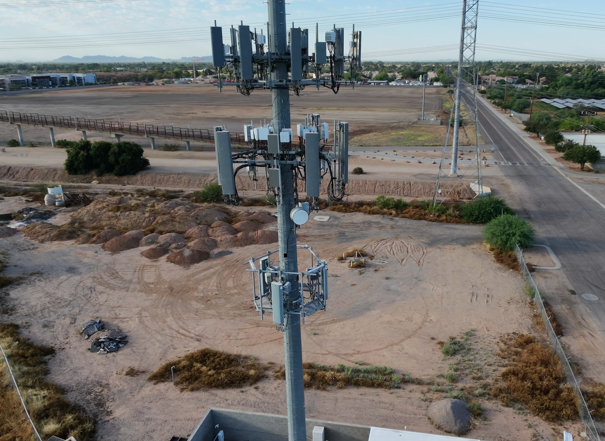 Close aerial view of cellular tower antennas and cabling during an inspection